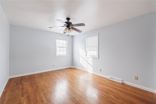 empty room featuring ceiling fan and hardwood / wood-style flooring