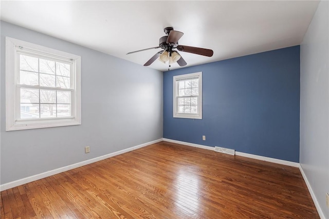 unfurnished room with ceiling fan and wood-type flooring