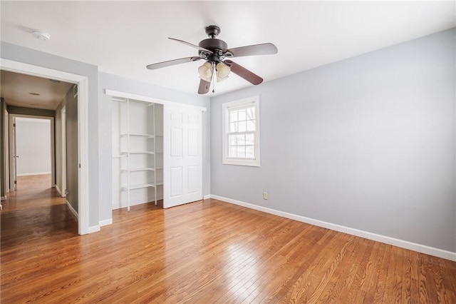 unfurnished bedroom with ceiling fan, light hardwood / wood-style floors, and a closet