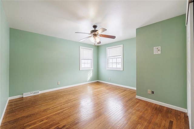 unfurnished room with ceiling fan and wood-type flooring