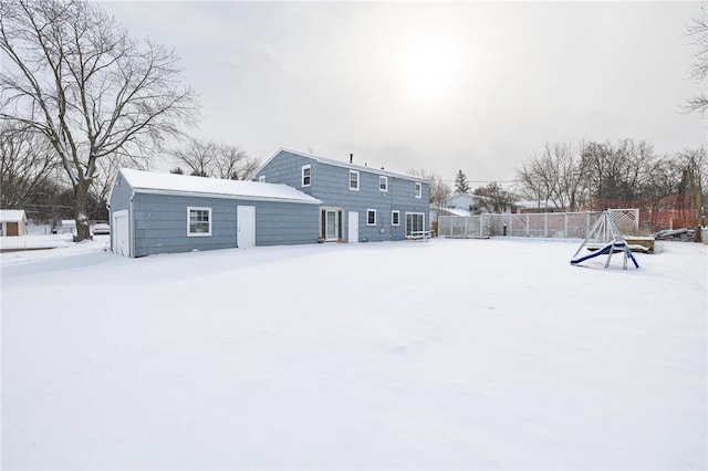 view of snow covered back of property