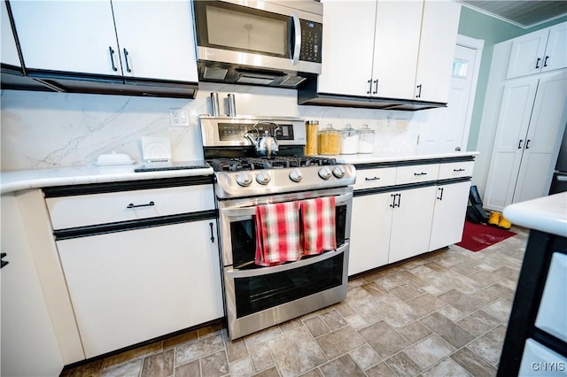 kitchen with stainless steel appliances, tasteful backsplash, and white cabinets