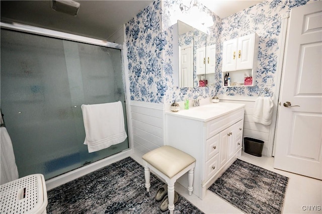 bathroom featuring walk in shower and vanity