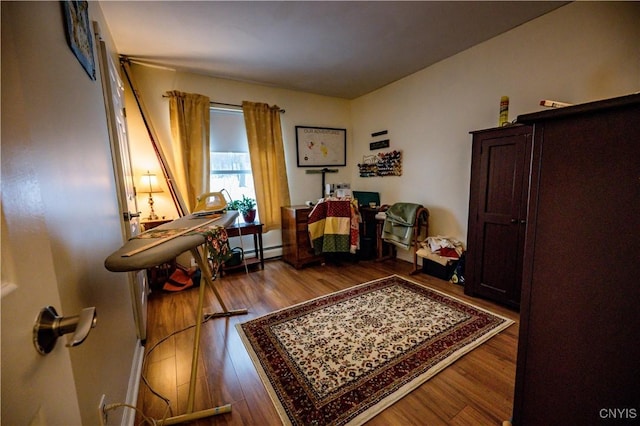 office area featuring a baseboard radiator and wood finished floors