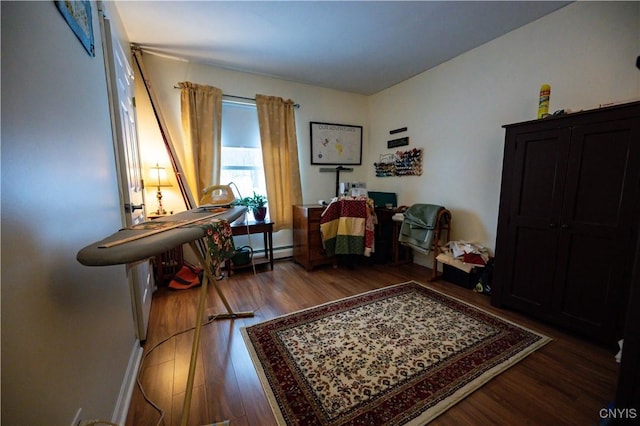 living area featuring dark wood-type flooring and a baseboard radiator