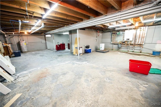 unfinished below grade area featuring water heater
