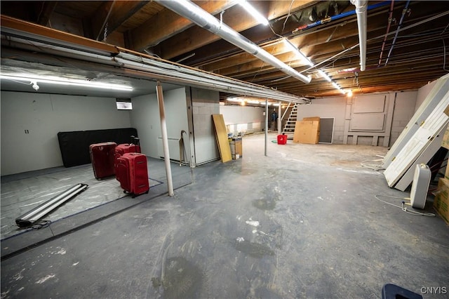 unfinished basement featuring stairs