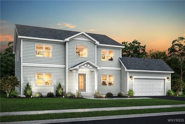 colonial inspired home with an attached garage, a shingled roof, aphalt driveway, and a front yard