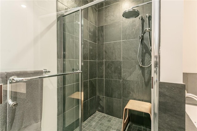 bathroom featuring a shower with door