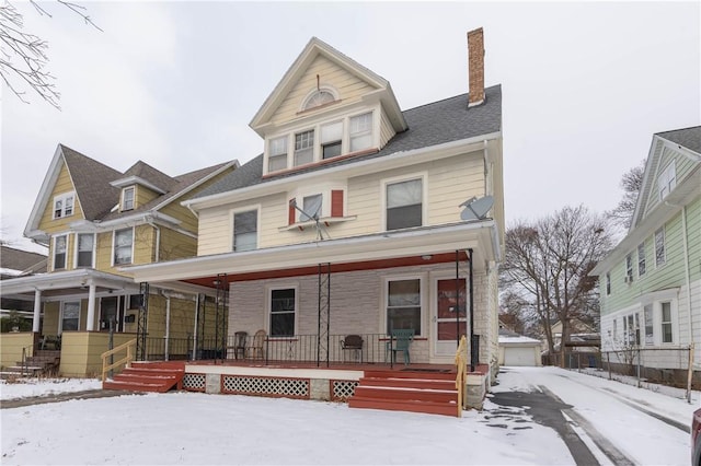 view of front facade with covered porch and a garage