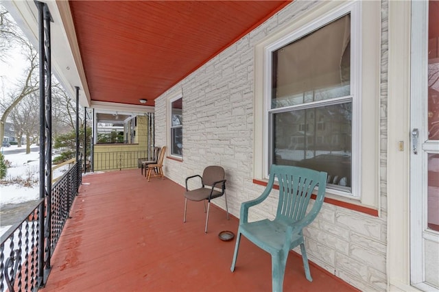 snow covered patio with covered porch