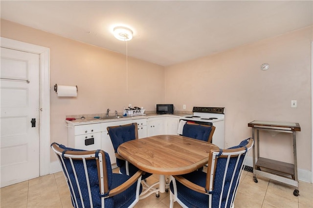 tiled dining room featuring sink