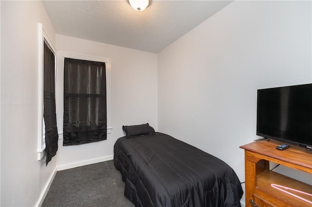 carpeted bedroom with a textured ceiling