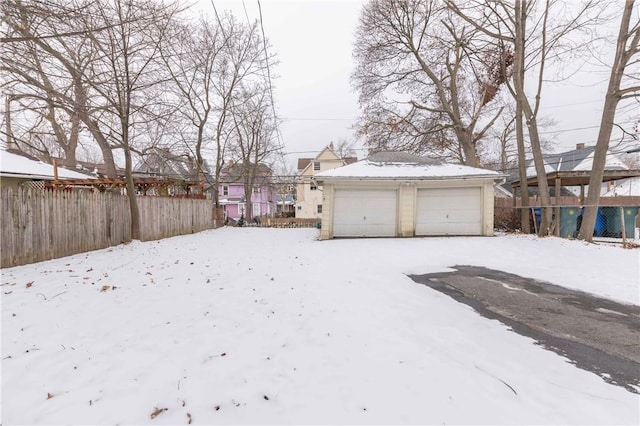 yard layered in snow with a garage