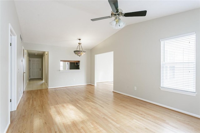 unfurnished living room featuring ceiling fan, vaulted ceiling, and light wood-type flooring