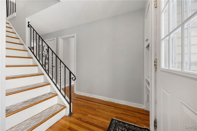 stairs featuring wood-type flooring