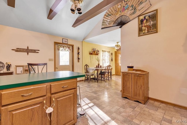 kitchen with ceiling fan and lofted ceiling with beams