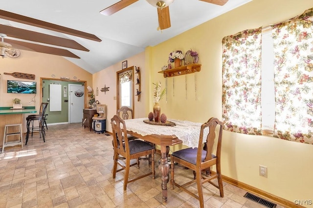 dining area featuring ceiling fan and lofted ceiling