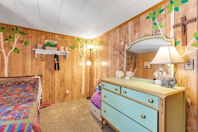 carpeted bedroom featuring wood walls