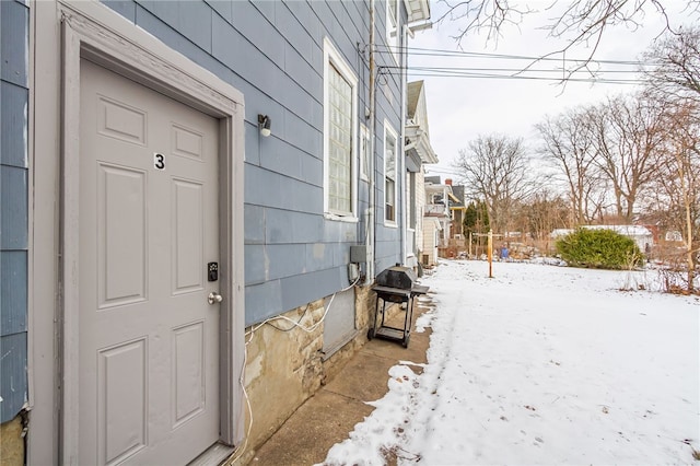 view of snow covered property entrance