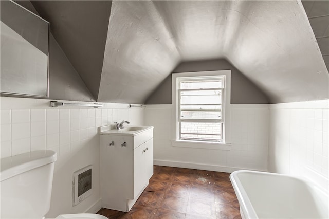 bathroom featuring toilet, a bathtub, parquet floors, heating unit, and vanity