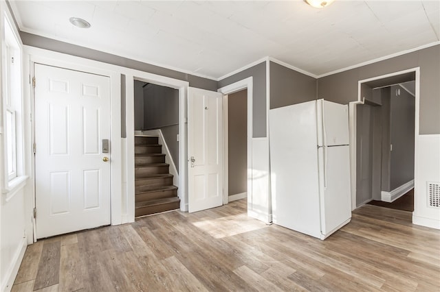 interior space featuring ornamental molding, white fridge, and light wood-type flooring