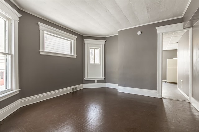 unfurnished room with crown molding