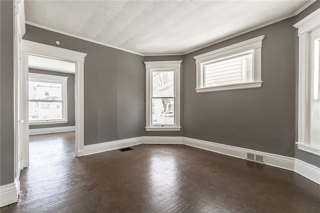 spare room with plenty of natural light and crown molding