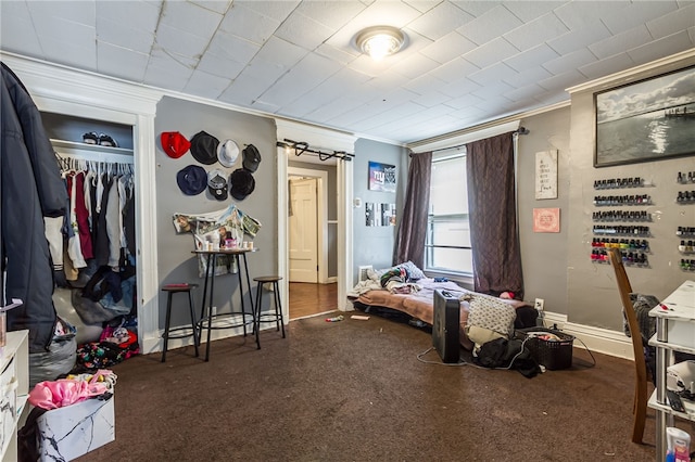 bedroom featuring a closet and crown molding