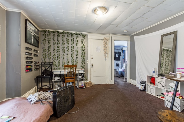 interior space featuring crown molding and dark carpet