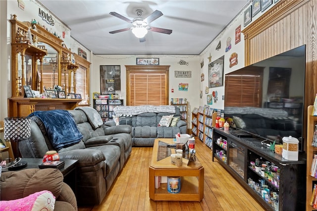 living room featuring ceiling fan and hardwood / wood-style floors