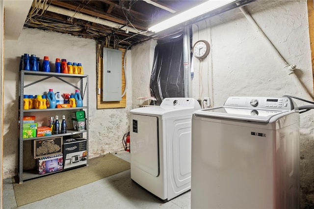 clothes washing area featuring washer and clothes dryer and electric panel