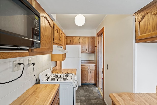 kitchen with white appliances and decorative backsplash