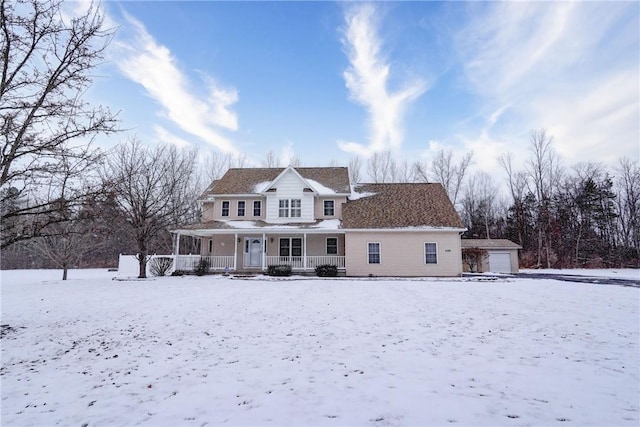 view of front of house with a garage, an outdoor structure, and a porch