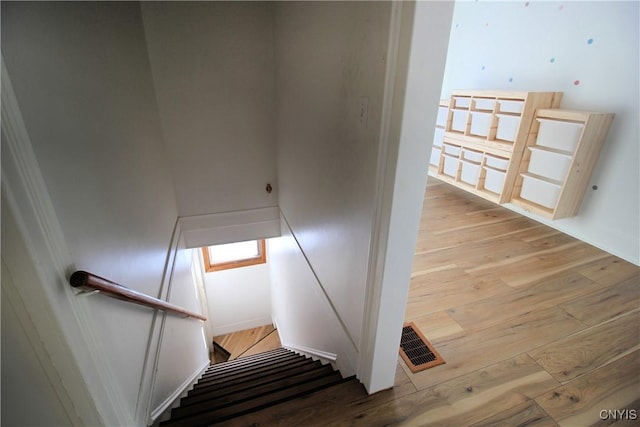 staircase with wood-type flooring