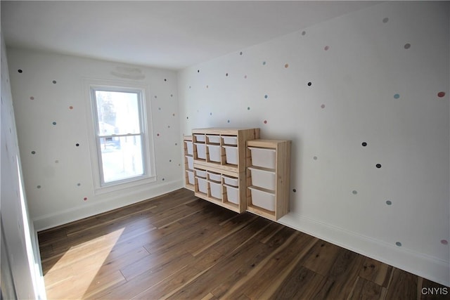 spare room featuring dark wood-type flooring