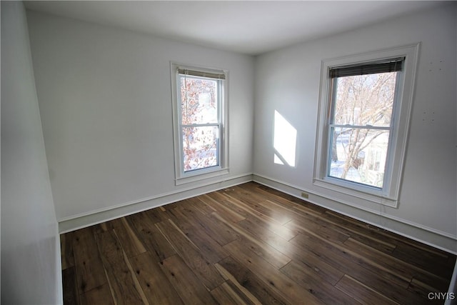 unfurnished room with dark wood-type flooring