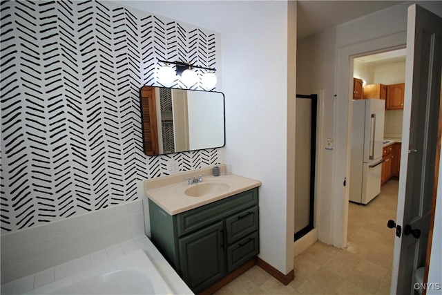 bathroom with vanity and separate shower and tub