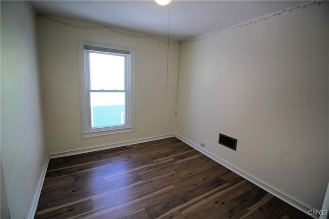 spare room featuring dark wood-type flooring