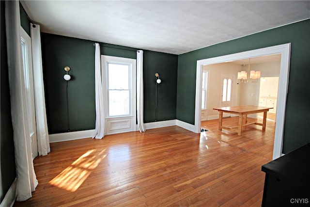 foyer entrance with hardwood / wood-style flooring and an inviting chandelier