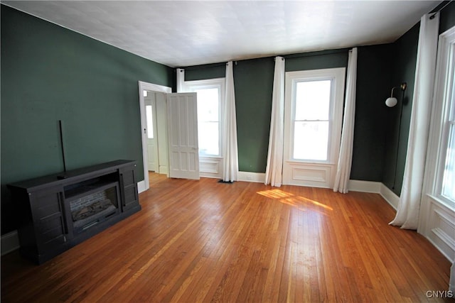 unfurnished living room with light hardwood / wood-style flooring