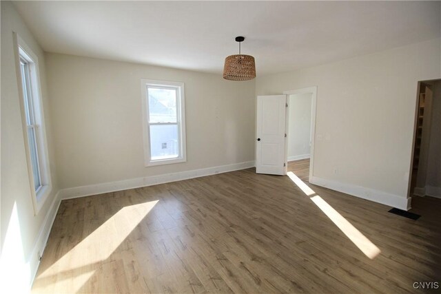 unfurnished room with dark hardwood / wood-style floors