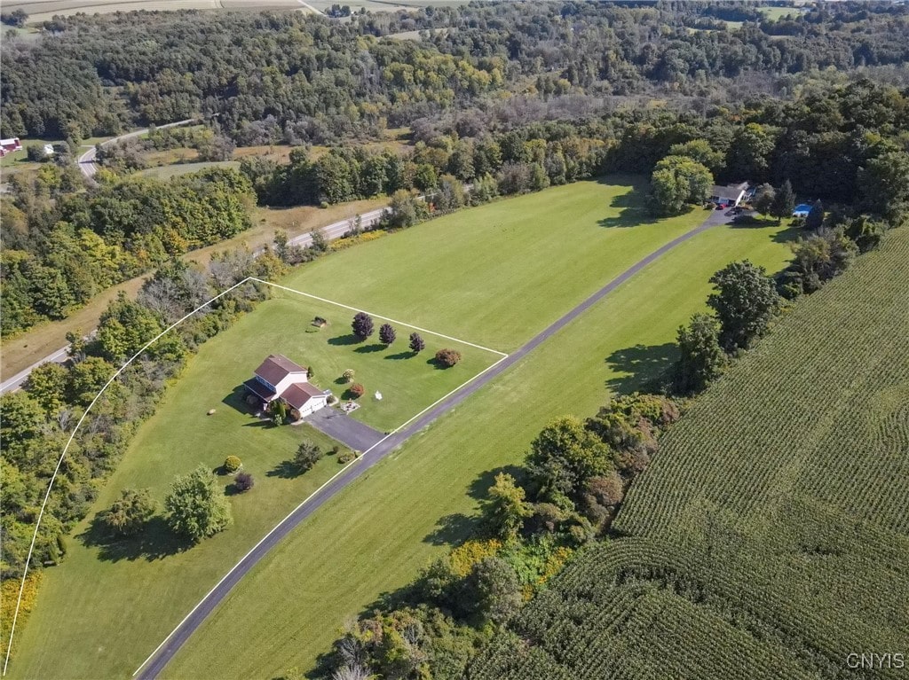 birds eye view of property with a rural view