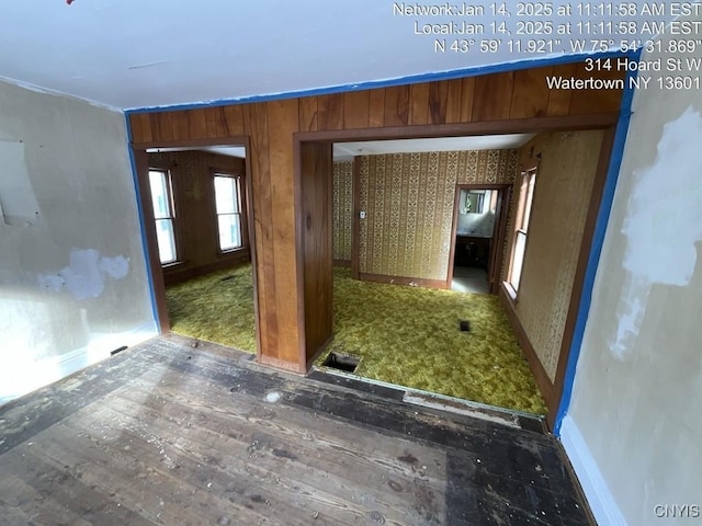 unfurnished room with wooden walls