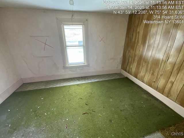 empty room featuring wooden walls