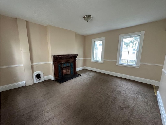 unfurnished living room featuring dark carpet