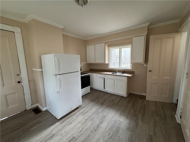 kitchen featuring white appliances, wood-type flooring, white cabinetry, sink, and ornamental molding