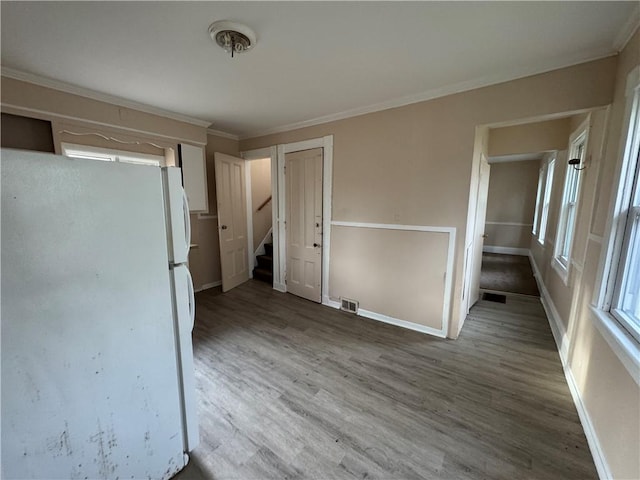 interior space featuring crown molding and hardwood / wood-style floors