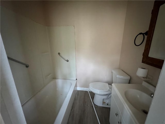 bathroom with wood-type flooring, toilet, and vanity