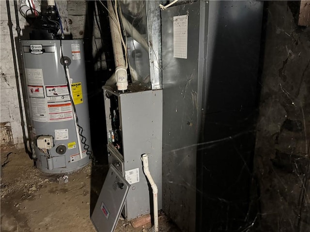 utility room featuring gas water heater and heating unit